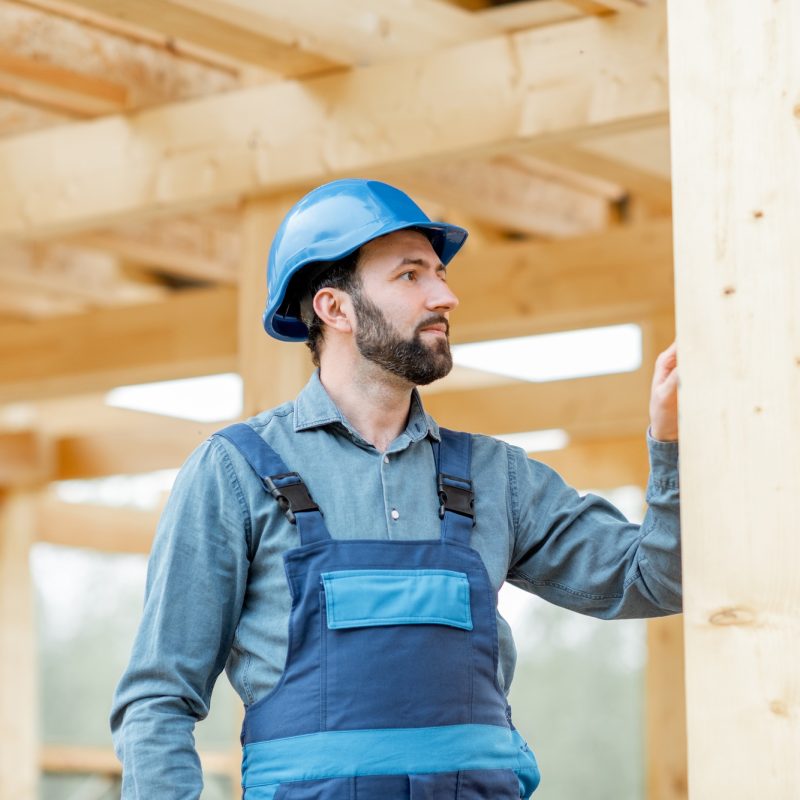 Builder on the wooden house structure
