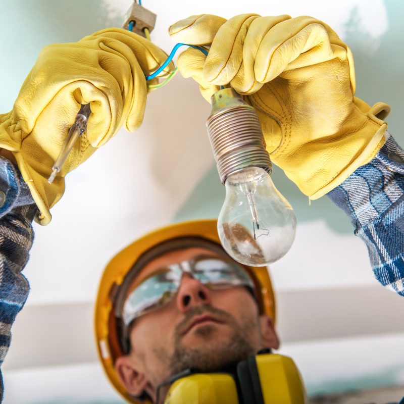 Electrician Checking Cables in a Lighting System to Fix a Bug