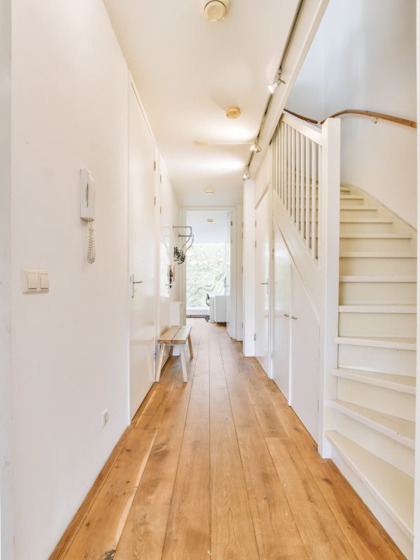 Light narrow hallway with staircase