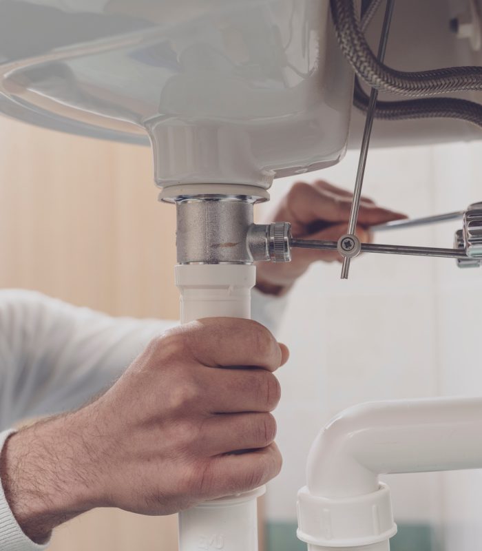 Plumber fixing a sink at home