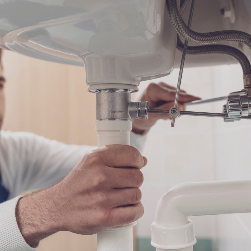 Plumber fixing a sink at home